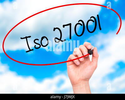 Man Hand writing Iso 27001  with black marker on visual screen. Isolated on sky. Business, technology, internet concept. Stock Photo Stock Photo