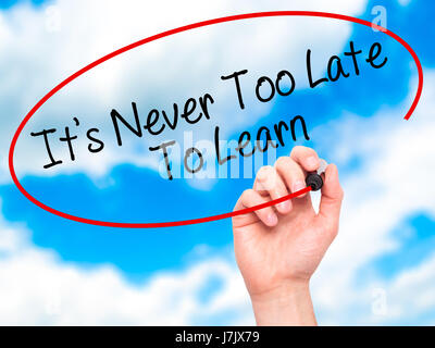 Man Hand writing Its Never Too Late To Learn with black marker on visual screen. Isolated on background. Business, technology, internet concept. Stock Stock Photo