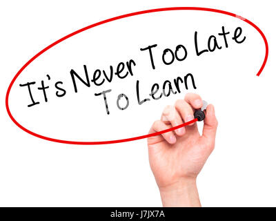 Man Hand writing Its Never Too Late To Learn with black marker on visual screen. Isolated on background. Business, technology, internet concept. Stock Stock Photo