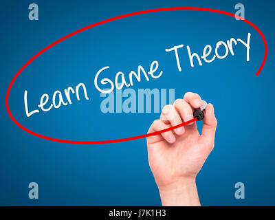 Man Hand writing Learn Game Theory with black marker on visual screen. Isolated on background. Business, technology, internet concept. Stock Photo Stock Photo