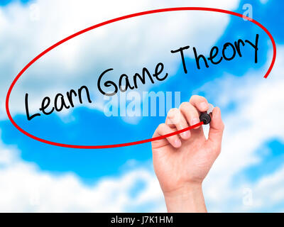 Man Hand writing Learn Game Theory with black marker on visual screen. Isolated on background. Business, technology, internet concept. Stock Photo Stock Photo