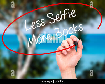 Man Hand writing Less Selfie More Books with black marker on visual screen. Isolated on nature. Business, technology, internet concept. Stock Photo Stock Photo