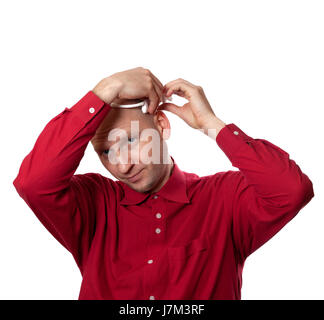 Young man in red shirt puts on head headset EEG (electroencephalography). Isolated on white background. Stock Photo