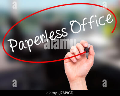 Man Hand writing Paperless Office  with black marker on visual screen. Isolated on office. Business, technology, internet concept. Stock Photo Stock Photo