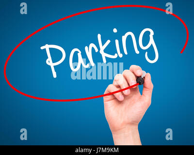 Man Hand writing Parking with black marker on visual screen. Isolated on blue. Business, technology, internet concept. Stock Photo Stock Photo