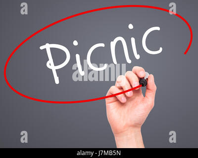 Man Hand writing Picnic with black marker on visual screen. Isolated on grey. Business, technology, internet concept. Stock Photo Stock Photo