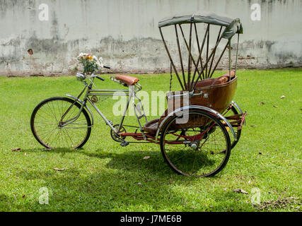 Thailand rickshaw three - wheeler Tricycle bicycle taxi for local people and tourists. old classic traditional asian tricycle Stock Photo