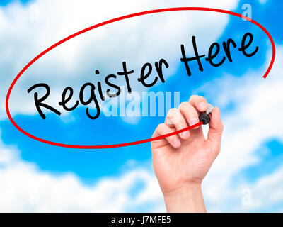 Man Hand writing Register Here with black marker on visual screen. Isolated on sky. Business, technology, internet concept. Stock Photo Stock Photo