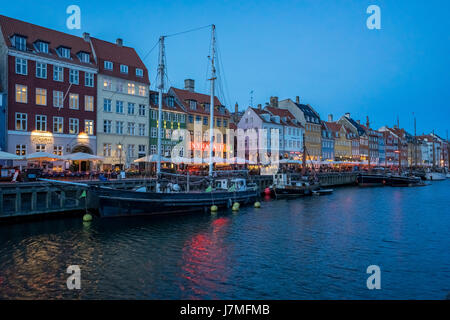 Copenhagen, Denmark - May 1, 2017: Nyhavn is a 17th-century waterfront, canal and entertainment district in Copenhagen, Denmark. Stock Photo