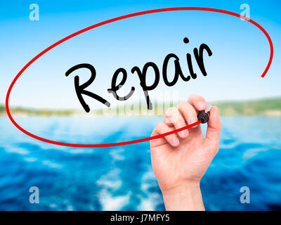 Man Hand writing Repair with black marker on visual screen. Isolated on background. Business, technology, internet concept. Stock Photo Stock Photo