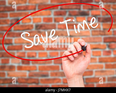 Man Hand writing Save Time with black marker on visual screen. Isolated on bricks. Business, technology, internet concept. Stock Photo Stock Photo