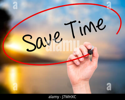 Man Hand writing Save Time with black marker on visual screen. Isolated on nature. Business, technology, internet concept. Stock Photo Stock Photo