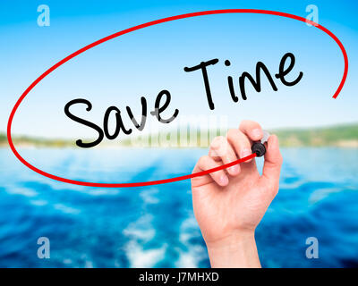 Man Hand writing Save Time with black marker on visual screen. Isolated on nature. Business, technology, internet concept. Stock Photo Stock Photo