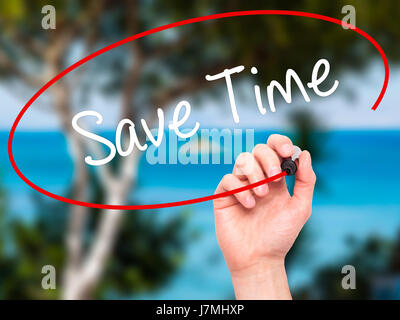 Man Hand writing Save Time with black marker on visual screen. Isolated on nature. Business, technology, internet concept. Stock Photo Stock Photo