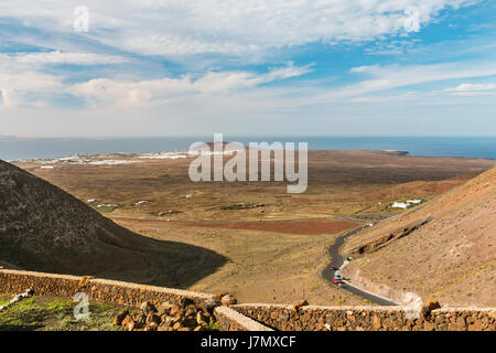 View from the Mirador de Femes in Lanzarote, Spain to Playa Blanca and Montana Roja, with Fuerteventura in the background. Stock Photo