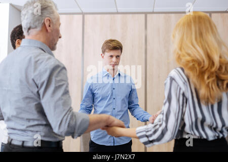 Pleasant nice people standing in the circle Stock Photo