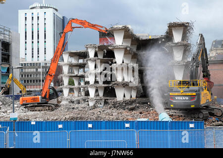 Demolition digger and buildings on construction site at Wood Street carpark near station Central Square, Cardiff City Centre, Wales UK  KATHY DEWITT Stock Photo