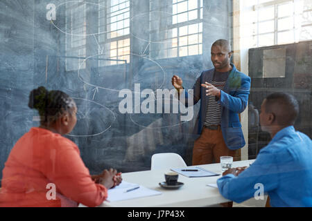 Young African businessman giving a presentation in an office Stock Photo
