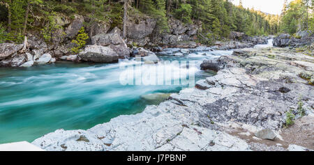 rushing water brook stream current gorge montana glacier garden wall landscapes forest trees alpine stream Stock Photo