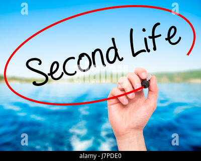 Man Hand writing Second Life with black marker on visual screen. Isolated on background. Business, technology, internet concept. Stock Photo Stock Photo