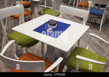 Modern and new wooden white set of table and chairs. Stock Photo