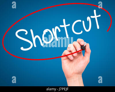 Man Hand writing Shortcut with black marker on visual screen. Isolated on blue. Business, technology, internet concept. Stock Photo Stock Photo