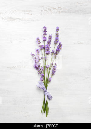 Bundle of lavender on old wooden board painted white. Stock Photo
