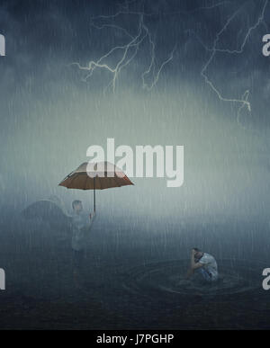 Surrealistic image as lonely, stressed man sit in the lake water below the falling rain and his angel try to help him giving an umbrella. Forgiveness, Stock Photo