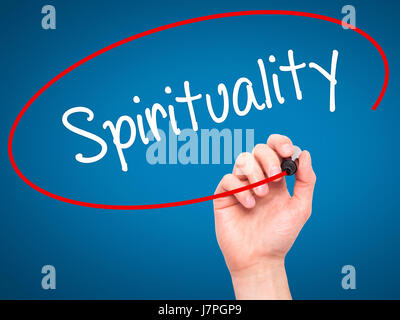Man Hand writing Spirituality with black marker on visual screen. Isolated on blue. Business, technology, internet concept. Stock Photo Stock Photo