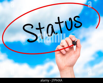 Man Hand writing Status with black marker on visual screen. Isolated on background. Business, technology, internet concept. Stock Photo Stock Photo