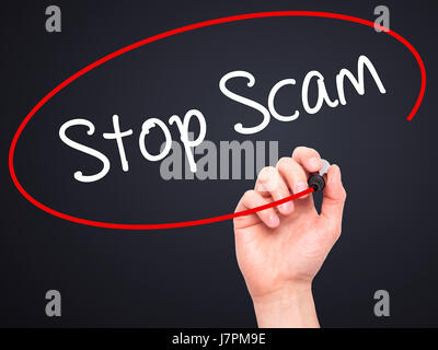 Man Hand writing Stop Scam with black marker on visual screen. Isolated on background. Business, technology, internet concept. Stock Photo Stock Photo