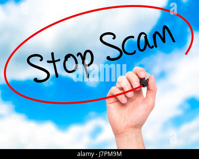 Man Hand writing Stop Scam with black marker on visual screen. Isolated on background. Business, technology, internet concept. Stock Photo Stock Photo