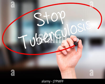 Man Hand writing Stop Tuberculosis with black marker on visual screen. Isolated on background. Business, technology, internet concept. Stock Photo Stock Photo
