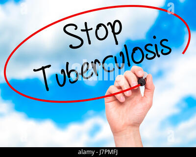 Man Hand writing Stop Tuberculosis with black marker on visual screen. Isolated on background. Business, technology, internet concept. Stock Photo Stock Photo