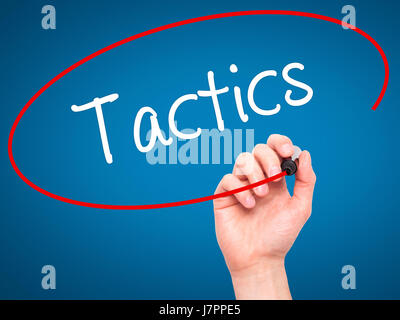 Man Hand writing Tactics with black marker on visual screen. Isolated on background. Business, technology, internet concept. Stock Photo Stock Photo