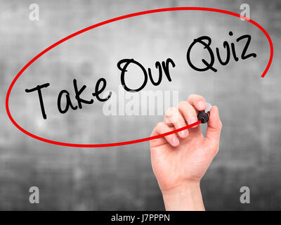 Man Hand writing Take Our Quiz with black marker on visual screen. Isolated on grey. Business, technology, internet concept. Stock Photo Stock Photo