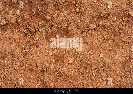 Tropical laterite soil or red earth background. Red mars seamless sand background. Top view Stock Photo
