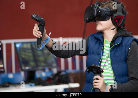 SEINT-PETERSBURG, RUSSIA - MAY 20, 2017: Boy tests the glasses of virtual reality at the exhibition of computer games, virtual reality exposition in Saint Petersburg, Russia Stock Photo