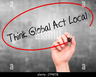 Man Hand writing Think Global Act Local with black marker on visual screen. Isolated on grey. Business, technology, internet concept. Stock Photo Stock Photo