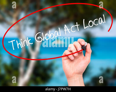 Man Hand writing Think Global Act Local with black marker on visual screen. Isolated on nature. Business, technology, internet concept. Stock Photo Stock Photo
