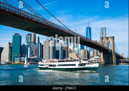 Bright scenic morning view of the Brooklyn Bridge and Lower Manhattan skyline as viewed from the shore of the DUMBO neighborhood in New York City Stock Photo