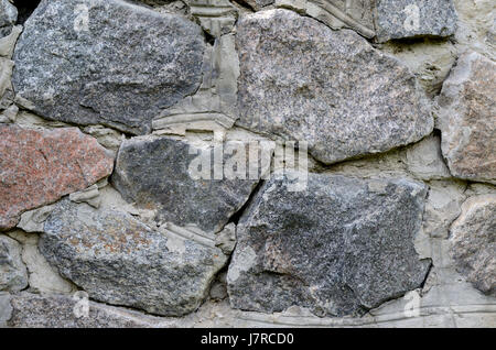 Old stone wall made of huge granite Stock Photo