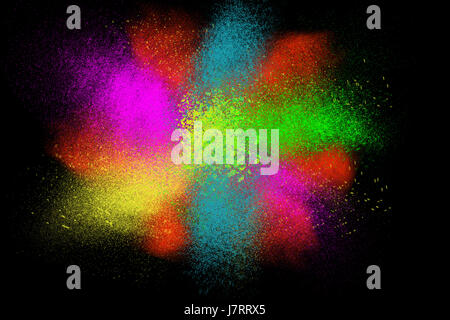 Freeze motion of colorful powder paint exploding isolated on black dark background. Abstract design of color dust cloud. Particles explosion screen sa Stock Photo