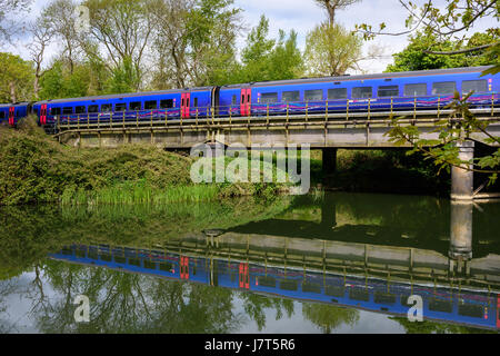 A train on the railway bridge over the River Avon at Bradford on Avon, Wiltshire, England. Stock Photo