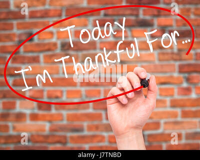 Man Hand writing Today I'm Thankful For... with black marker on visual screen. Isolated on bricks. Life, technology, internet concept. Stock Image Stock Photo