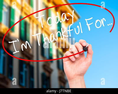 Man Hand writing Today I'm Thankful For... with black marker on visual screen. Isolated on city. Life, technology, internet concept. Stock Image Stock Photo