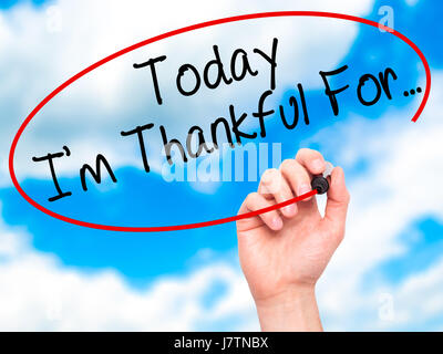 Man Hand writing Today I'm Thankful For... with black marker on visual screen. Isolated on sky. Life, technology, internet concept. Stock Image Stock Photo