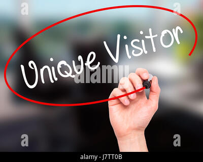 Man Hand writing Unique Visitor with black marker on visual screen. Isolated on background. Business, technology, internet concept. Stock Photo Stock Photo