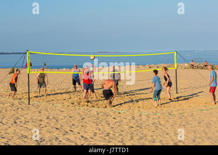 People having fun playing beach volleyball at Sandbanks beach, Poole, Dorset in May Stock Photo