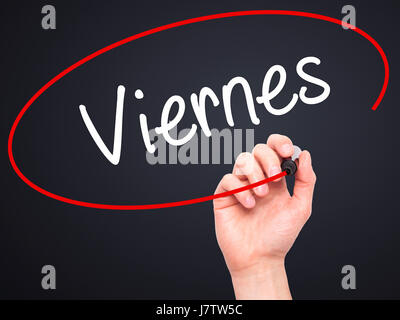 Man Hand writing Viernes (Friday in Spanish) with black marker on visual screen. Isolated on black. Business, technology, internet concept. Stock Phot Stock Photo